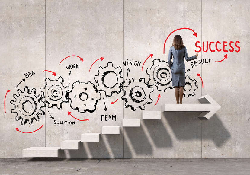 Back view of businesswoman draw gears mechanism on wall