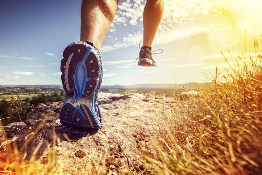 Outdoor cross-country running in summer sunshine concept for exercising, fitness and healthy lifestyle